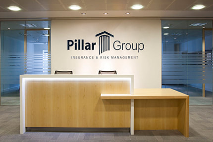The Pillar Group logo printed on the wall